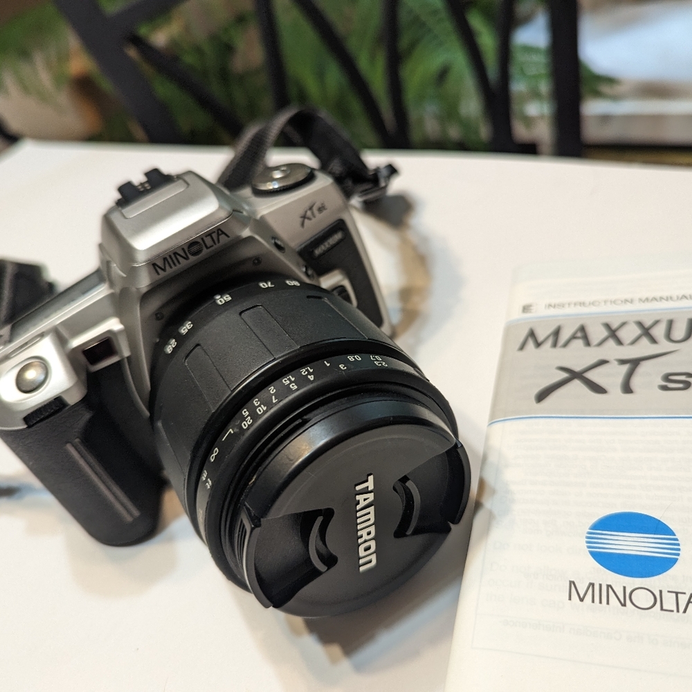 Minolta Maxxum xTsi SLR camera with lens, filters, and case